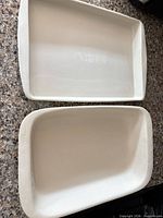 Top view of both cream stoneware baking dishes