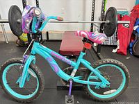 Left side full view of bicycle showing frame, wheels, handlebar bag and saddle