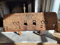 overall view of carved wooden sleigh footboard showing full design and wear