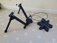 trainer stand with resistance unit, cable, and riser block on floor