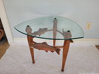 American black walnut side table with glass top, three legs, carved trout supports
