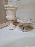 Tall alabaster urn and shorter footed bowl showing shapes, stone veining and relative sizes