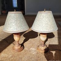 Both alabaster lamps with shades and finials displayed side by side