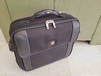 Front view of black SwissGear Wenger laptop briefcase showing logo, zip compartments and carry handle