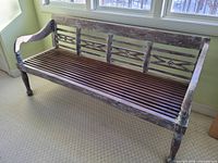 Full view of teak bench showing whitewashed frame, slatted seat, decorative back, turned legs