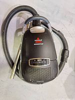 Overall view of Bissell Momentum canister vacuum with hose and wand