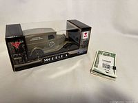 Boxed Ford Model A truck plus stack of Canadian Tire money