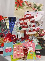 Assortment of gift bags, bows, ribbon spools, boxes and tissue displayed