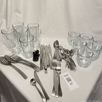 Overview of glasses, flatware, serving utensils, salt and pepper shakers