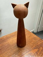 full view of wooden cat figurine standing on table