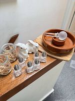 Entire lot showing salt rimmer on wood board, glass reamer, bunny shakers, mini glass shakers, votive jars