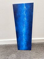 Front view of vertical blue canvas with lightning bolt