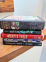 Stack of five books showing spines and titles