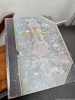 Front of worn book-style Myst case