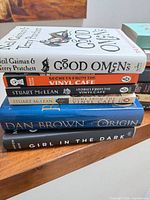 Stack one showing Good Omens, three Vinyl Cafe titles, Origin, Girl in the Dark