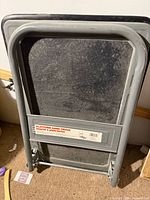 Hand truck folded, showing handle and deck