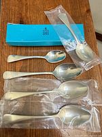 All five sterling silver spoons with Birks box and three sealed in plastic