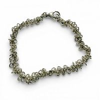 Bracelet laid in closed circle showing jump ring texture and clasp