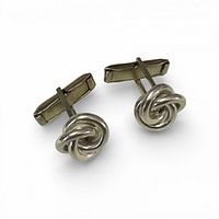 Front view of cufflinks showing knot design