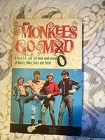 Front cover showing title, author details, photo of The Monkees