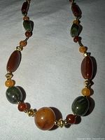 Full view of 30-inch brown and green stone bead necklace