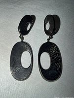 Full view of both clip-on earrings showing design and length