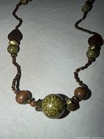 Close-up of central section with large glass globe bead, wood and stone beads