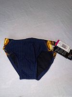 Front view of navy and gold TYR swim brief