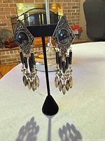 front view of earrings on stand showing overall design