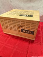 Three-quarter view of box showing GAJA logo and slatted design