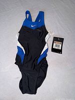 Front view of Nike girls swimsuit with attached retail tags