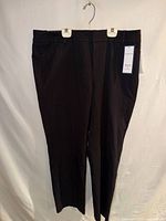 Front view of black slim leg pants with hanger