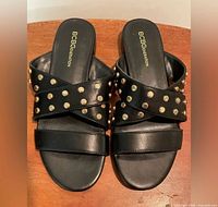 Top view of sandals showing studded crisscross straps and brand logo on insoles