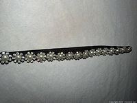 Full view of black elastic headband showing pearl and rhinestone decoration