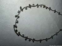 Close-up of left side showing bead accents and light blue stones