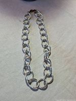 Full view of necklace laid flat showing length and clasp