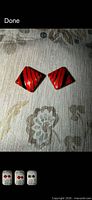 Front view of red and black striped diamond clip-on earrings
