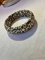 Side view of satin leopard print bangle