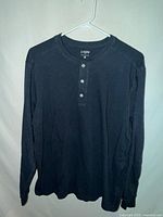 Front view of blue J.Crew long sleeve Henley T-shirt on hanger