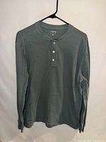 Front view of green J.Crew henley T-shirt on hanger