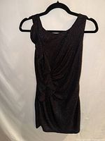 Full view of black Hailey Logan sleeveless ruched dress on hanger