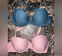 Front view of teal and light pink ribbed bikini tops