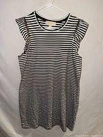 Full view of striped Michael Kors dress on hanger