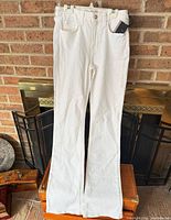 Full front view of white Jen7 jeans showing overall condition