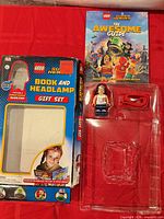 Front view of open gift set showing empty box, book, headlamp blister tray