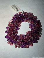 Overall view of bracelet showing crystal beads and tag