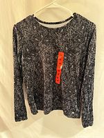 Front view of new Hang Ten floral long-sleeve sun shirt with size tag visible