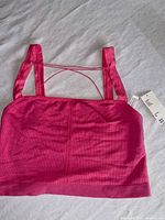 Full view of pink ribbed bra top front with tags