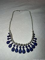 Full view of necklace showing silver beads and blue stones