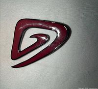 Front view of burgundy enamel brooch